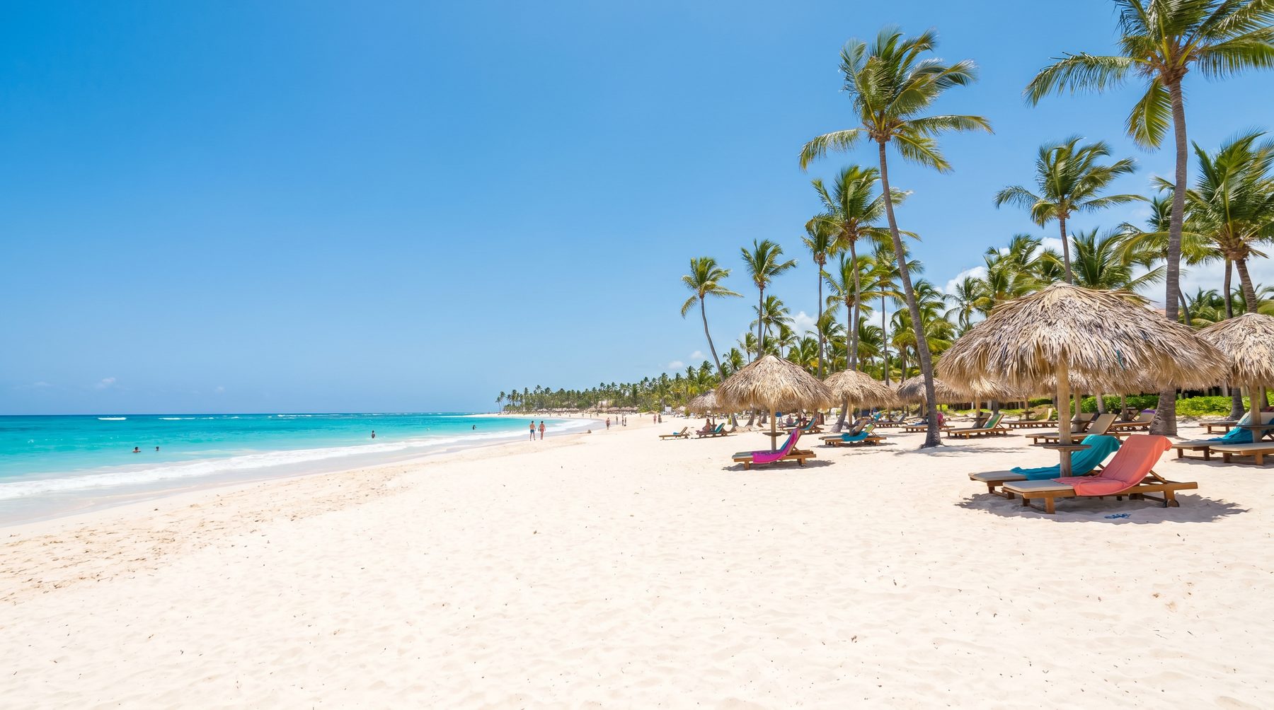 White-sand beach with palms and umbrellas